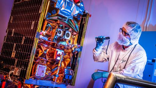 Aerospace engineer performs final checks before the GPIM satellite is shipped to Florida for launch