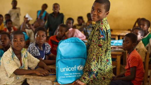Boy posing with UNICEF book bag