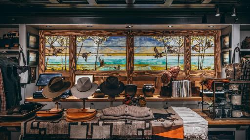 A display table with hats, sweaters, and scarves.