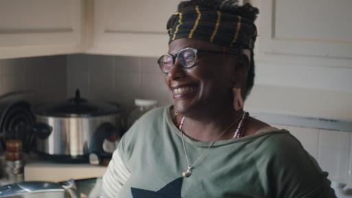 Woman in kitchen smiling