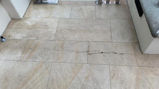 Large cracking at flooring tiles, due to a multitude of workmanship issues.