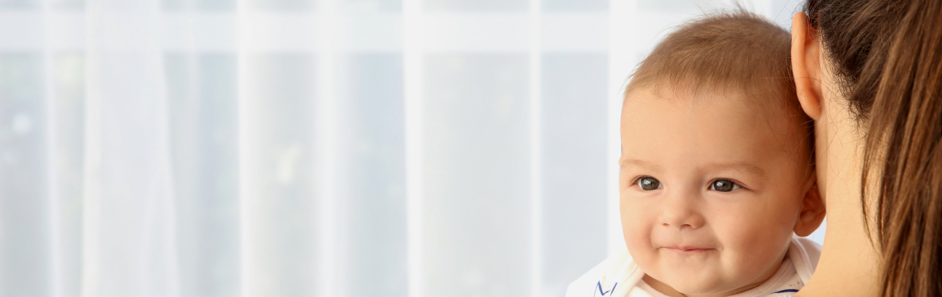 Baby smiling and being held