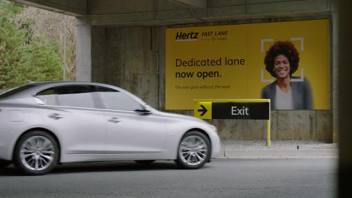 Car driving towards the exit of the Hertz Fast Lane