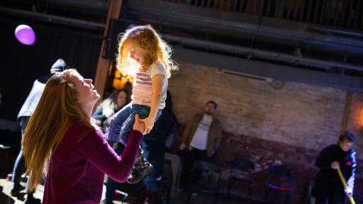 Mother holding child up in the air
