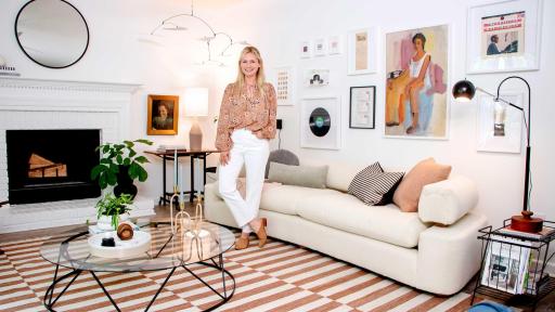 Emily Henderson, Author of STYLED, stands in the living room she designed with a personalized gallery wall and other lease-friendly ideas
