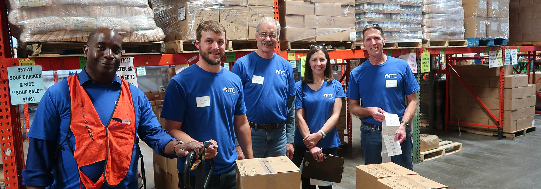 Employees behind food boxes