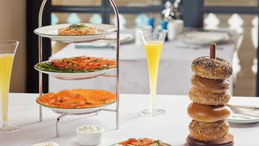 Tripple platter Tower with Sadelle's House Salmon and Salmon Salad  with a plate of bagels on a white tablecloth