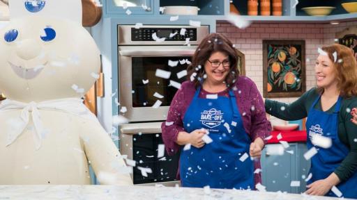 Winner and Doughboy stand in kitchen with confetti falling