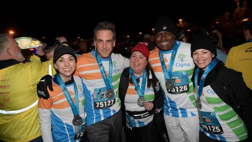 Carlos shows off his medal arm in arm with fellow athletes.