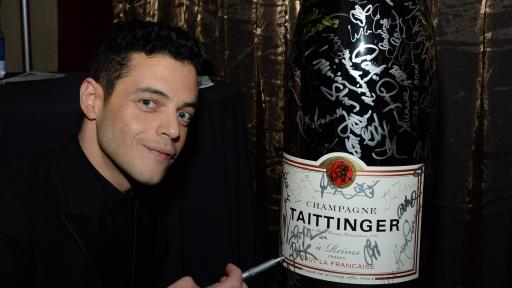 Rami Malek adds signature to Champagne Taittinger’s bottle activation at the 25th Annual Screen Actors Guild Awards on January 27, 2019.