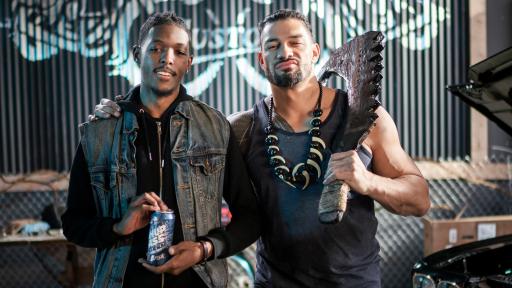 Men each holding a Brisk can in a garage