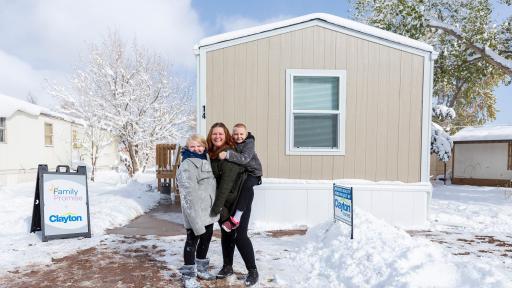 Woman with her two kids in front of the new home