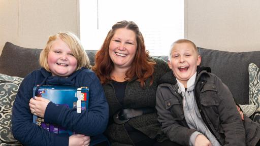 Woman on a couch with her grand-kids