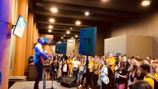 Jordan Kirkdorffer on guitar performing on stage.