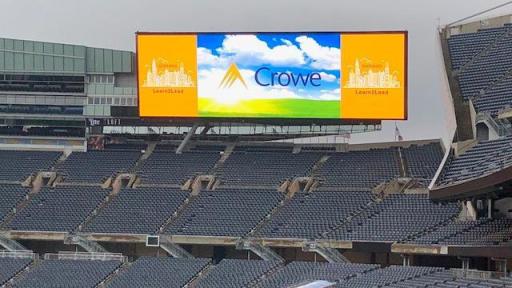 A Learn2Lead ad on a giant screen in Soldier Field stadium