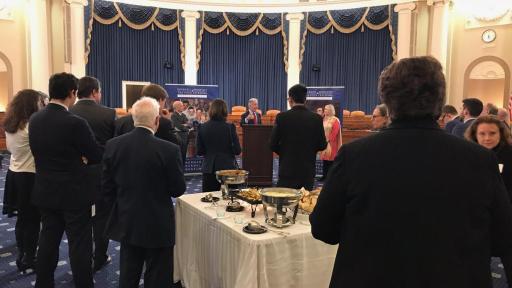 Two men in front of a podium presenting the  “Enduring Ideals: Rockwell, Roosevelt and the Four Freedoms” collaboration  to Congress