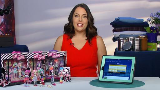 A woman in red dress standing behind a table.