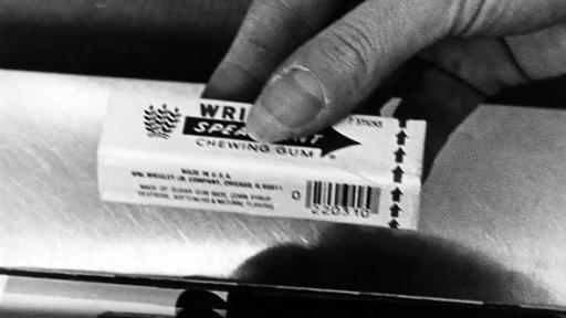 Black and white photo of a pack of gum being scanned