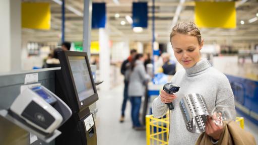 Woman using a self-checkout scanner