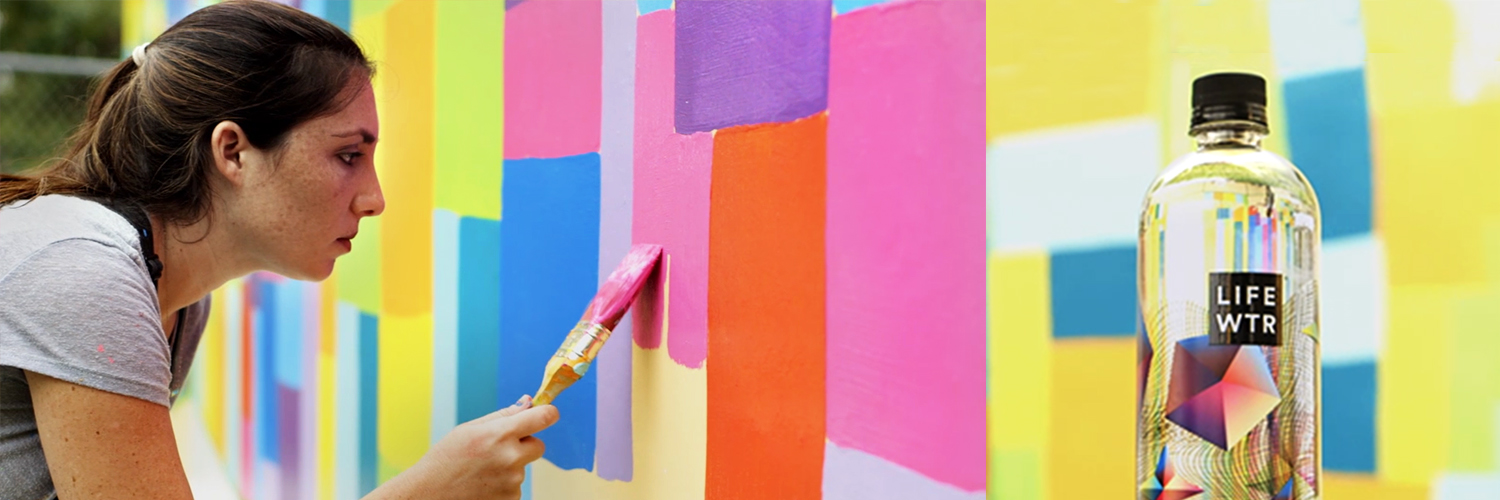Banner image of a woman painting a LIFE WTR mural