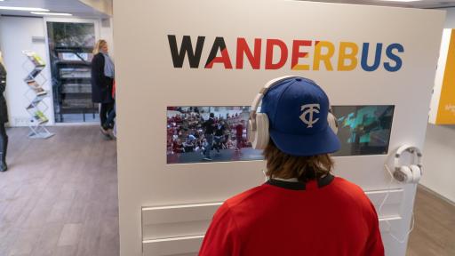 Person watching WanderbUS video