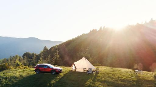 SUV parked near a camping tent