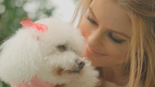 Maria Whinnie holds a poodle