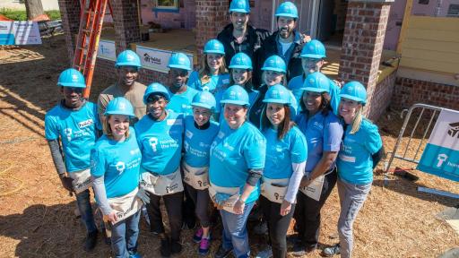 A group of people working with Habitat for Humanity.