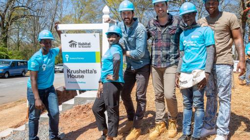 Group of people standing in front of sig for Krushette's House #HomeIsTheKey