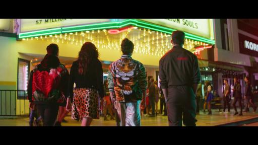 Four people walking into a theater