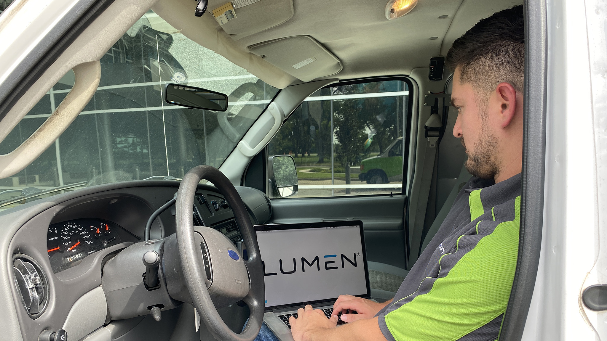 Technician working on a laptop in a truck