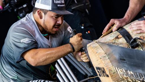 Rainer Shooter cuts a giant log with a chainsaw
