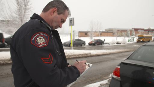 Police Officer writes Second Chances ticket for a Calgary resident