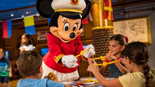Captain Minnie Mouse helping girls tie knots