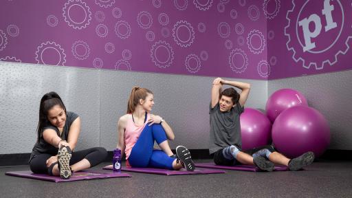 Two teenage females stretching together
