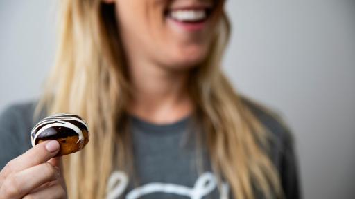 Woman holding a miniature donut
