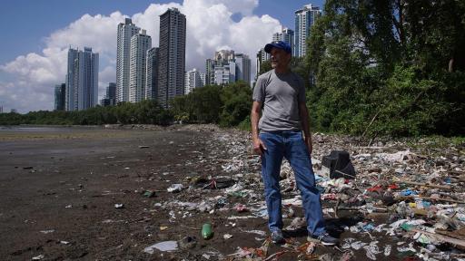 Image of the Turning the Tide sustainability guide in front of a beach full of garbage