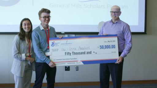 Jeff Harmening, CEO and chairman of General Mills, presents $50,000 to Ugo and Emma Angeletti