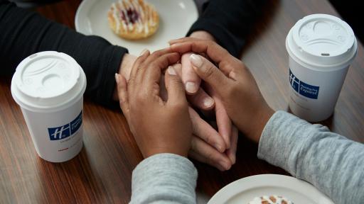 A couple holding hands at a table