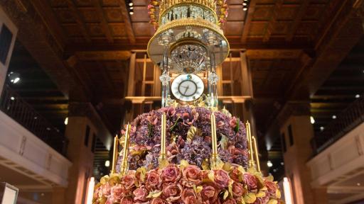 The Celebration Cake in the front lobby surrounded by people.