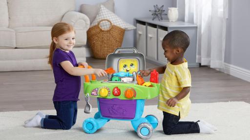 Girl and boy playing with the LeapFrog&reg; Smart Sizzlin&rsquo; BBQ Grill&trade;