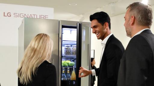 Man showing others LG refrigerator