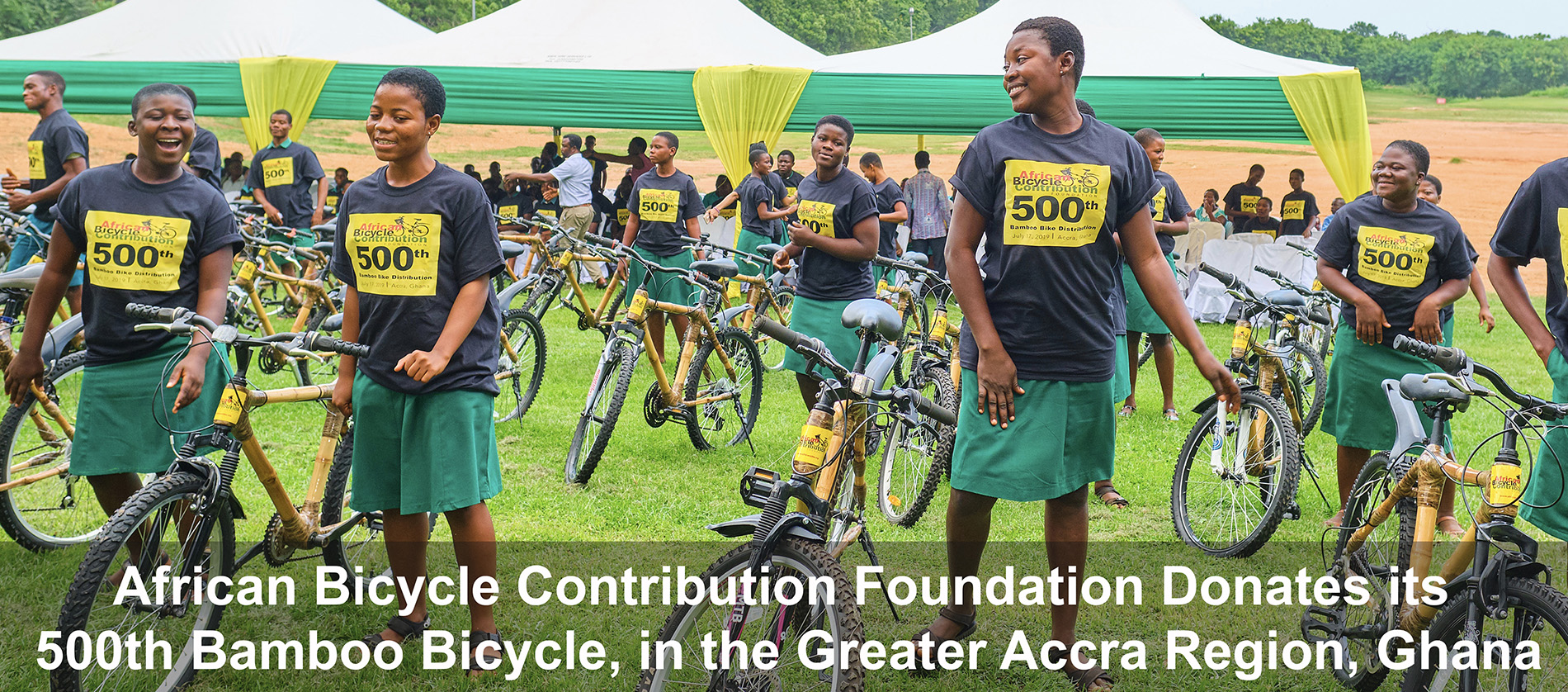 Young women holding their new bikes.