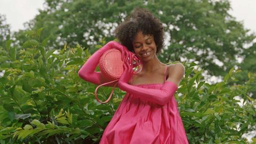 Model in a pink dress with pink tights.
