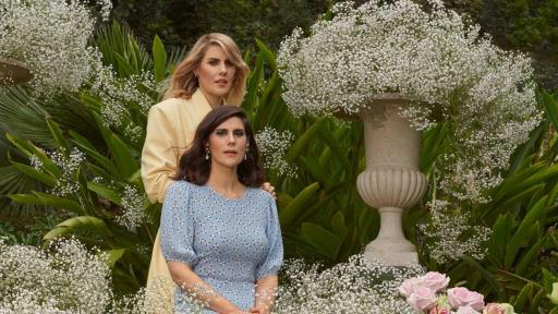 Kate and Laura Mulleavy, Founding Designers of Rodarte  surrounded by baby's breadth flowers and roses.