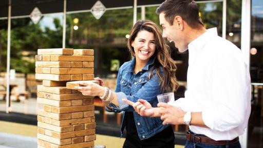 Two people looking at a column of bricks