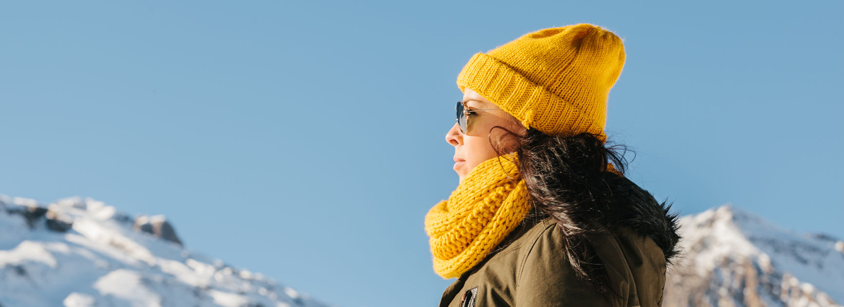 Woman standing outside on snowy mountains