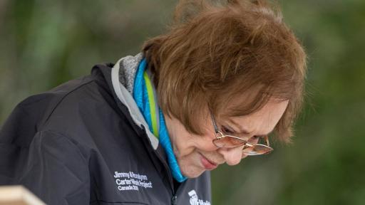 Rosalynn Carter painting a home