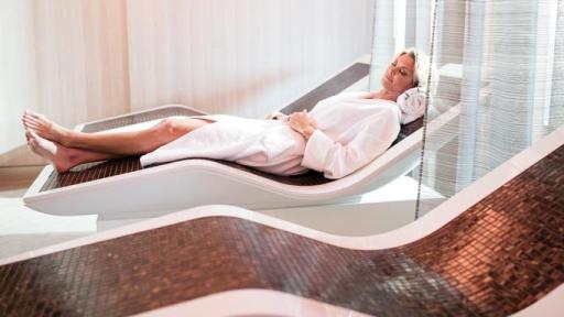 Woman relaxing on spa couch