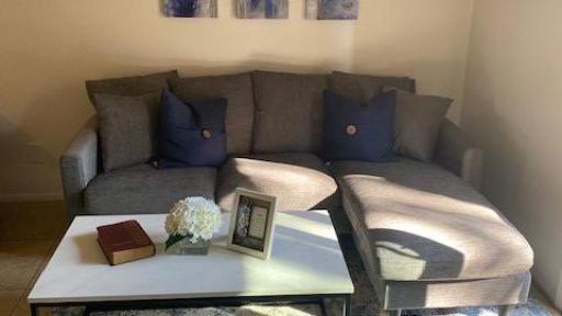 Grey couch with a table